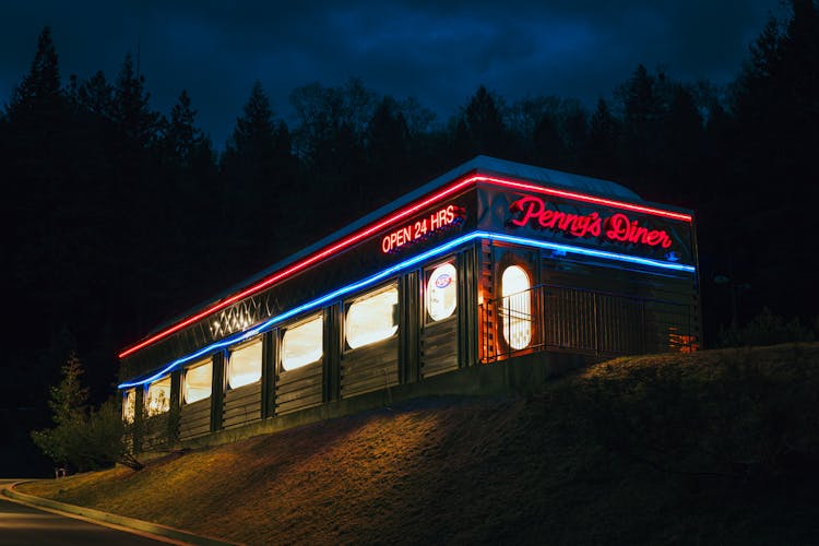 Local restaurant storefront at night with warm lighting - every one is a potential recurring commission